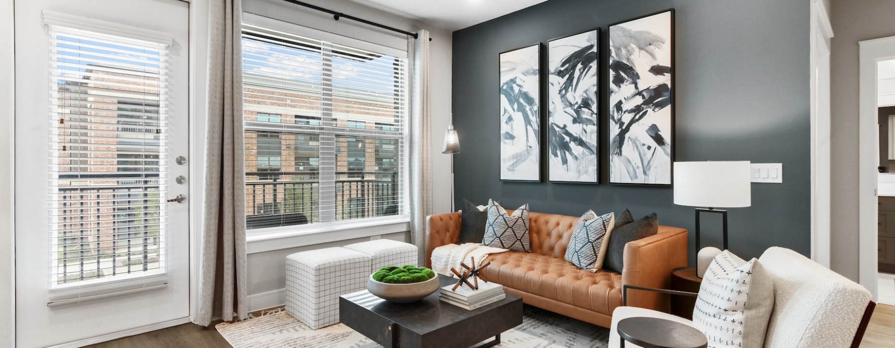 Spacious living room with large windows and high ceilings