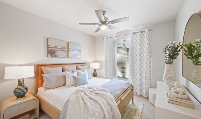 Spacious bedroom with natural lighting and ceiling fan